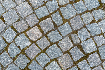 Natural stone background and texture in gray color close up. Pavement paved with square and uneven...