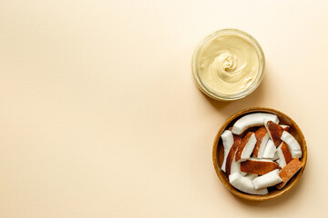 Jar of coconut butter cream with fresh coconuts. Sugar and lactose free vegan food.