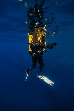 Diver suspended in clear blue ocean waters