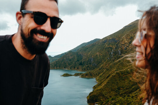 Couple enjoying scenic view of a lake in Sao Miguel, Azores.