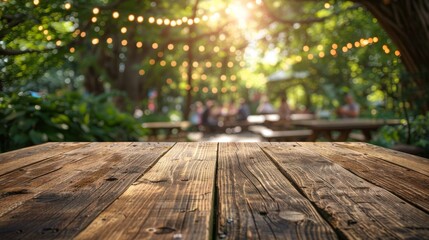 A rustic wooden table top against a blurry background of a sunny garden party