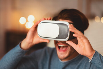 Excited Man Using VR Glasses Having Fun Playing Videogame At Home. Selective Focus