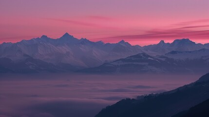 Obraz premium Mountain Range Silhouette at Sunrise With Pink Sky and Fog