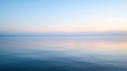 Obraz premium Calm Water and Clear Skies at Sunrise on a Lake