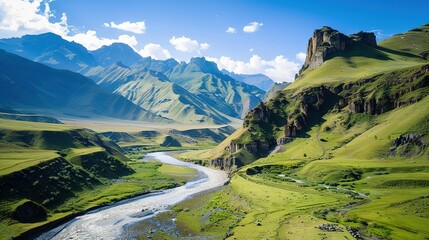 Fototapeta premium Winding River Through Lush Green Valley in the Caucasus Mountains on a Sunny Day
