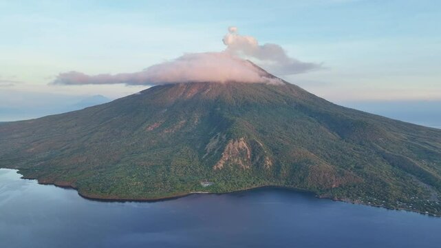 A serene dawn illuminates the scenic volcano of Lewotolok on island of Lembata, Indonesia. This beautiful and biodiverse area is part of the famed Ring of Fire and is volcanically active.