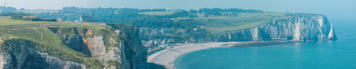 Aerial view of Etretat cliffs and the Atlantic ocean. Chalk cliffs and three natural arches. Panoramic path to admire the coast. Normandy region of Northwestern France. 06-26-2024