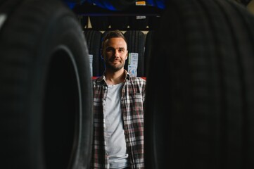 Man chooses winter car tires in the auto shop