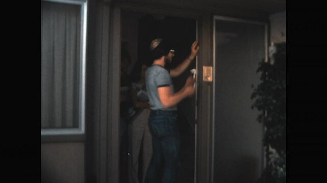 Affixing Mezuzah 1978 - A young Jewish couple affixes a Mezuzah to the doorpost of their home as prescribed in the religious tradition, in Berkeley, California, 1978.