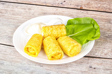 Stuffed pancakes with cream sauce