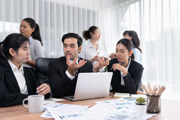 Diverse group of business analyst team analyzing financial data report paper on office table. Chart and graph dashboard by business intelligence analysis for strategic marketing planning Meticulous