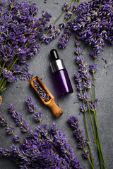 Glass bottle of lavender essential oil with fresh lavender flowers. Spa procedures and...