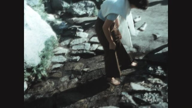 Dipping Her Toes 1975 - A woman dips her toes in a stream during a visit to Yosemite National Park in 1975. 