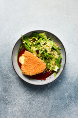 Grilled camembert cheese with vegetables and blackberry sauce. Close up.