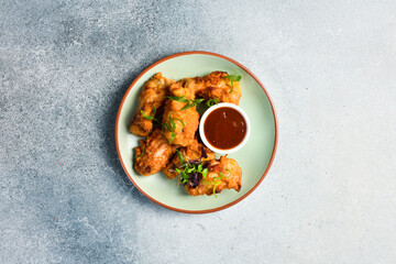 Buffalo chicken wings with sweet chili sauce. Close up. Top view.