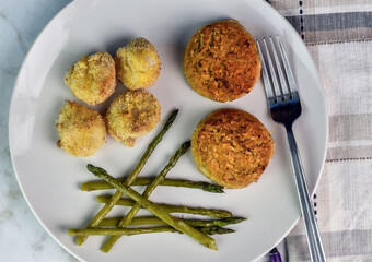 two crab cakes  served with baked scallops