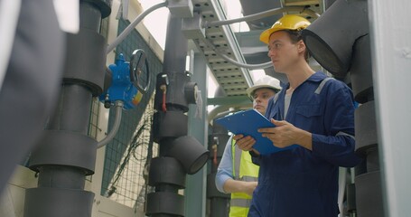 Civil engineer manager and foreman worker checking industry cooling air conditioner water cooling...