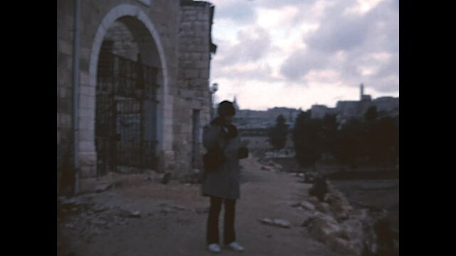 Jerusalem Street Food 1975 - A man wearing an Russian ushanka enjoys a sandwich as he walks in Jerusalem, in 1975.