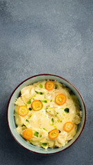 Italian farfalle pasta with cheese and kumquat. In a plate. Close up.