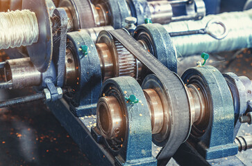 Transmission mechanism. Part of machine production of cords plastic reinforcement for construction.