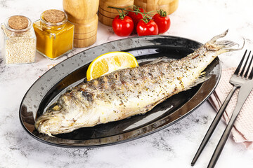 Grilled sea bass fish served lemon