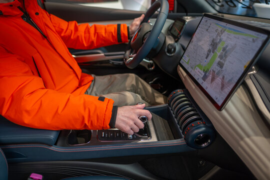 man in car driving BYD ATTO 3 Car Electric Car, male hand on center console, button switches, joysticks, EV Chinese BYD manufacturer, Interior equipment, Frankfurt, Germany - January 31, 2024
