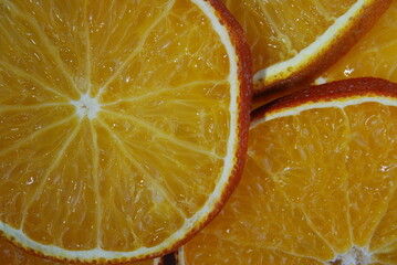 slices of dried orange in the peel are laid out on the surface