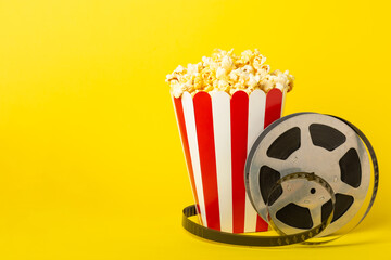 Tasty popcorn in buckets and cold cola drinks with cinema tickets, movie clapper and 3D eyeglasses...