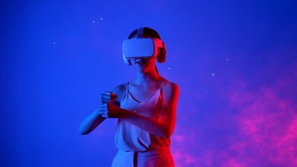 Fototapeta premium Woman player using VR transfer to fantastic metaverse fencing game box material neon by sword laser fantasy gaming space with lighting bokeh on blue smoke in meta 3D cyberspace world. Hallucination.