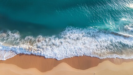 Birch sea and sandy shore. Aerial view of a transparent sea splashing on a sandy beach. Ocean waves from a bird's eye view.