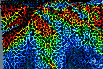 Texture of multi colored metallic paper, artificially illuminated in this interior space, intricate...