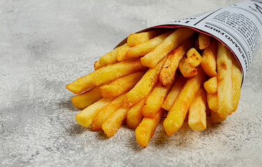Fried French fries in a paper bag, on an abstract background, without people, in a rustic style,
