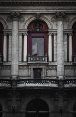 The photo showcases the stunning facade of the Lyon Theater, featuring elegant columns, intricate carvings, statues, and striking red accents, highlighting its architectural beauty.
