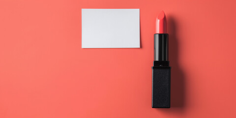 One opened coral lipstick tube lying on a colorful background with a blank white business card