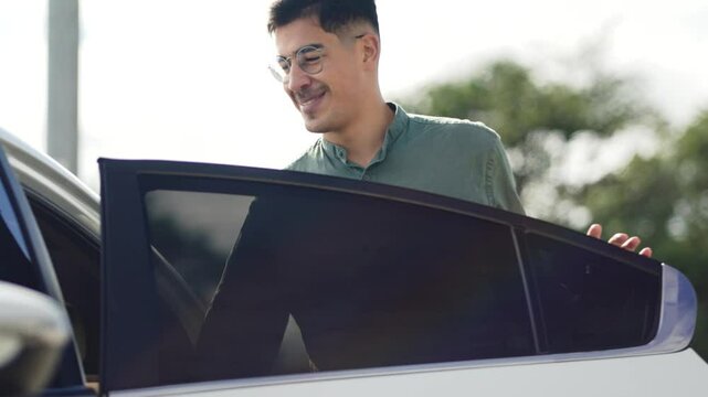Smiling Man with Glasses Getting into Passenger Seat of Car. Cheerful Male in Green Shirt Entering Vehicle, Emphasizing Rideshare Experience and Modern Urban Commuting