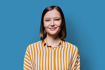 Young smiling attractive woman on blue background