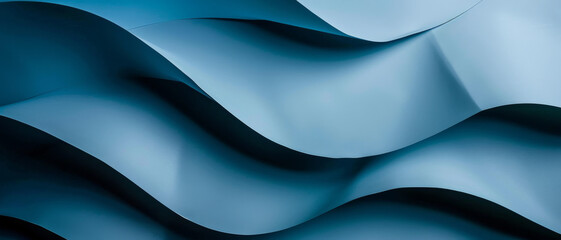 Artistic close-up of blue abstract waves, the smooth curves and shadows creating a visually soothing and flowing image.