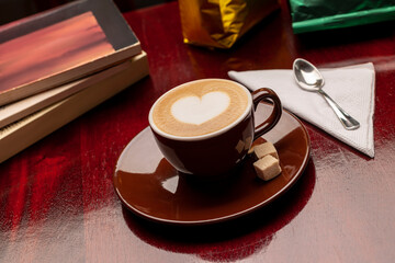 8 ounce cappuccino style coffee mug with books around it.