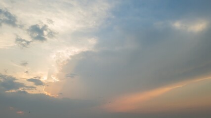 A serene sunset sky with soft clouds symbolizes tranquility and peaceful reflection, ideal for nature or relaxation concepts