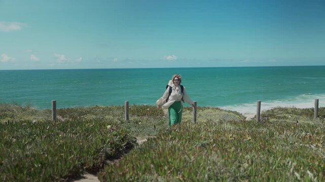 Caucasian woman hiking along the Atlantic coast in Portugal