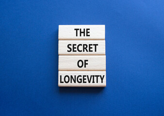 The Secret of Longevity symbol. Wooden blocks with words The Secret of Longevity. Beautiful deep blue background. Business and The Secret of Longevity concept. Copy space.