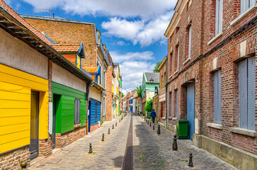 Colorful houses of Amiens historical city centre Saint-Leu quarter. Narrow cozy street between brick buildings old town in France, Picardy, Somme department, Hauts-de-France Region, Northern France