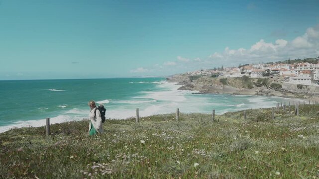 Caucasian woman hiking along the Atlantic coast in Portugal