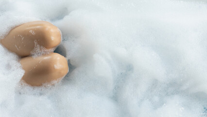 woman takes dip in the soapy mineral water in the jacuzzi service offered by the luxury resort to its guests. The young woman is enjoying the jacuzzi alone to relax and have a whirlpool massage.