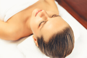 Closeup caucasian woman customer enjoying relaxing anti-stress spa massage and pampering with beauty skin recreation leisure in day light ambient salon spa at luxury resort or hotel. Quiescent