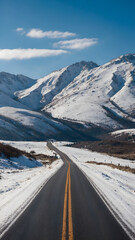 Long road through snowy mountains 