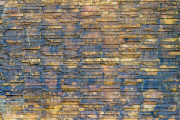 Naklejka premium Brick wall background is a wall made of clay bricks, giving the structure strength and cement line between bricks that looks beautiful. It is popular to build a wall of ancient monuments.copy space,
