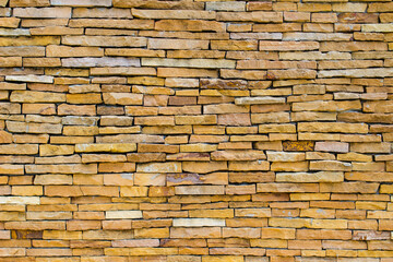 Fototapeta premium Brick wall background is a wall made of clay bricks, giving the structure strength and cement line between bricks that looks beautiful. It is popular to build a wall of ancient monuments.copy space,