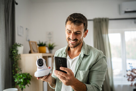 Adult man at home connect install cctv security surveillance camera