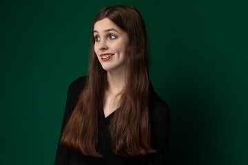 Woman With Long Hair Standing in Front of Green Wall